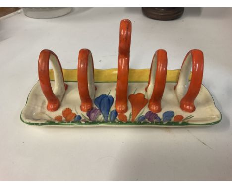 A Clarice Cliff patterned toast rack.