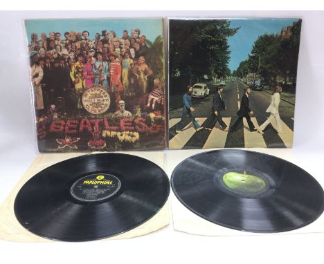 A first UK pressing of 'Abbey Road' with misaligned Apple logo on back cover and missing 'Her Majesty' credit, together with 
