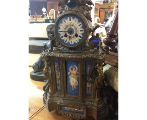 A French gilt mantle clock the top surmounted with birds inset with porcelain panels 50 cm .