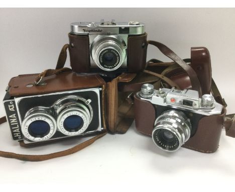 Three vintage cameras comprising a Voigtlander Vito 8 and two models by Halina (3). Shipping category B.