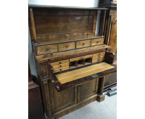 A Quality Regency Rosewood Secretaire cabinet the raised back with a brass three quarter gallery pillar supports with brass c