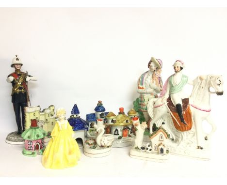 A collection of Staffordshire porcelain including figures, a swan inkwell, houses and also including a Royal Worcester figure