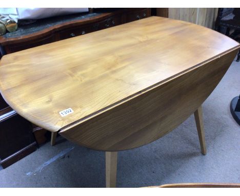 A Ercol drop leaf table with five chairs