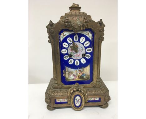 A French late 19th century gilt metal and porcelain mantel clock with painted porcelain panels. For spares or restoration. Hi