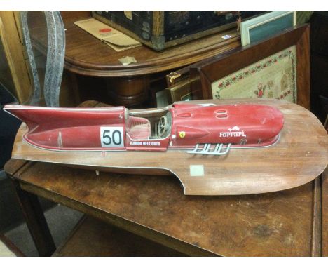 A model of a vintage motorboat in Ferrari livery, approx length 76cm. Shipping category D.