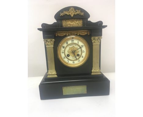 A late Victorian black slate and marble mantel clock the enamel dial with the inscription Ferber & Son Paris the vase with ap