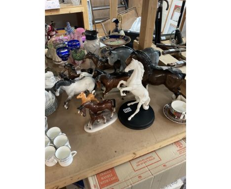 A collection of Beswick and other ceramic horses.