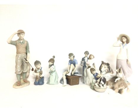 A collection of ceramic figures including Lladro, Nadal& other. Postage cat D