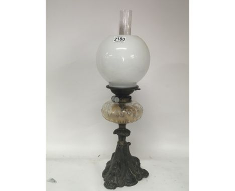 A Victorian oil lamp with an opaque glass shade the metal base with stylised Egyptian influence. Hight 62cm