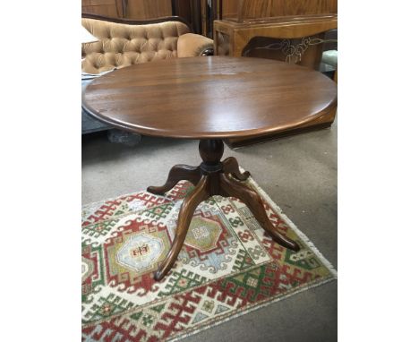 An Ercol dinning table with a circular top on a turned column on splayed legs. 100cm very good condition