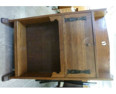 An early 20thC oak bureau, having a galleried top, over a fall flap, enclosing a fitted interior, over a height adjustable sh