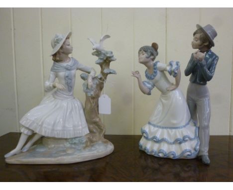 Two Nao porcelain  figures, viz. a woman in a garden beside a bird on a branch  10''h; and a young Spanish couple, dancing  9