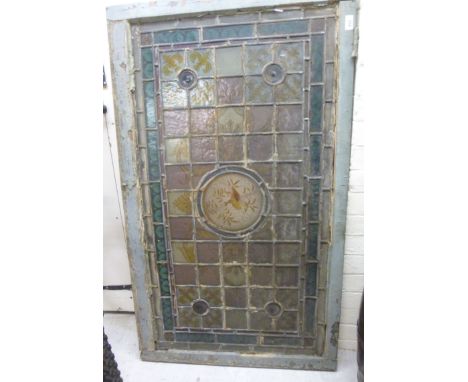 A late 19thC coloured lead glazed window panel, featuring a hedgerow bird in a central vignette, bullseye and other ornament 