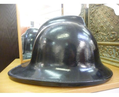 A Cromwell moulded black and green lacquered fireman's helmet, Country style, no.F135, impressed 1972  size 7.5''          CA