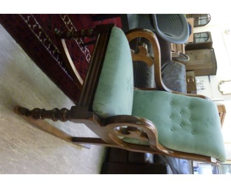 A Victorian mahogany framed rocking chair, the sage green, part button upholstered back and seat raised on ring turned, taper