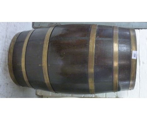 An early 20thC coopered barrel design, oak oval stick stand, having lacquered brass bands and a compartmented aperture  26''h