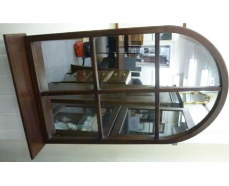 A modern Juckes mirror, the segmented plate set in an arched mahogany frame, incorporating a base shelf  36'' x 22''       LS