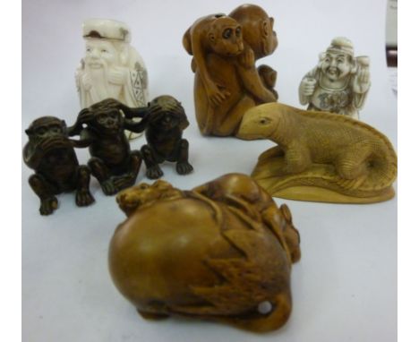 Four similar modern Japanese carved wooden netsuke style wooden ornaments: to include a monkey with her young; and a two bone