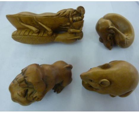 Four similar modern Japanese carved wooden netsuke style miniature ornaments: to include a fieldmouse holding a nut         S