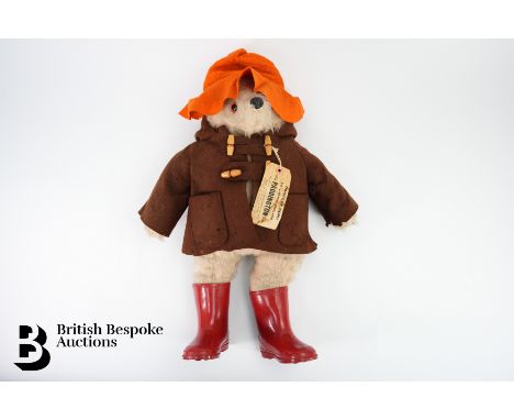 A vintage Paddington Bear, manufactured by Gabrielle Designs, 957892, circa 1972, wearing a brown felt coat, red wellies and 