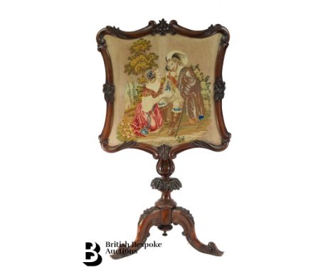 Victorian pole screen, with a shield shaped screen worked with a tapestry, turned column on a tripod base, approx 107 cms h.&