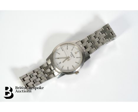 Gentleman's Tissot stainless steel wrist watch. The watch case measures 38mm, having a white face with chrome baton markers, 