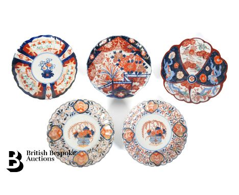 Near pair of Japanese Imari plates, scalloped edges painted with flowers and buddhist symbolism, the central reserve decorate