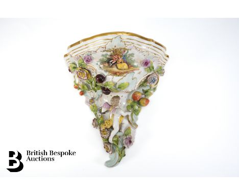 Dresden (Carl-Johann Thieme 1823-1888) porcelain flower and fruit encrusted wall console, with a putti moulded in relief, app