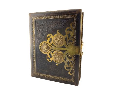 Victorian stamped leather photograph album with cut brass mounts and clasp containing portrait photographs