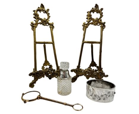 Pair of modern brass easel stands H24cm, silver bangle, glass scent flask with silver collar and pair of folding lorgnettes