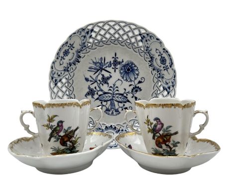 Pair of late 19th century German porcelain chocolate cups and saucers, of quatrefoil form painted with birds and insects, wit