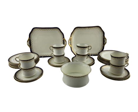 Cauldon tea set decorated with a blue and gilt border pattern comprising eight cups, twelve saucers, twelve plates, sugar bow