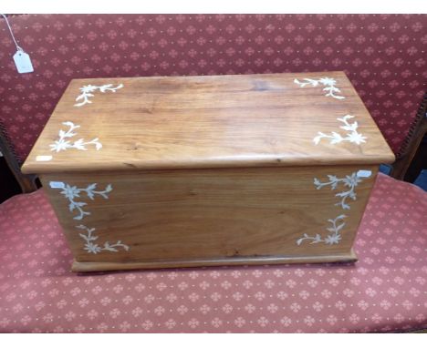 A SMALL TEAK TRUNK WITH MOTHER-OF-PEARL INLAY 61cm wide