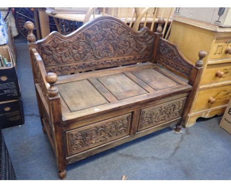 A HALL BENCH WITH CARVED PANELS arched back and knob finials (reproduction) 100cm wide