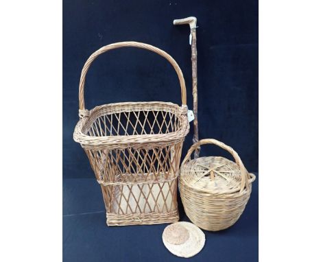 A WICKER LAUNDRY BASKET with high hoop handle, a smaller circular wicker basket with lid, and a hedgerow walking stick with a