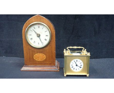 AN EDWARDIAN BRASS CARRIAGE TIMEPIECE RETAILED BY HARRODS 8.5cm high, with key (cracked to dial) and an Edwardian lancet-shap