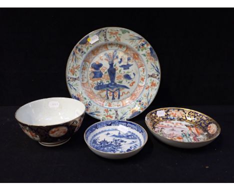 A CHINESE EXPORT BLUE AND WHITE SAUCER another with enamelled decoration and a matching slops basin, and a plate (4)