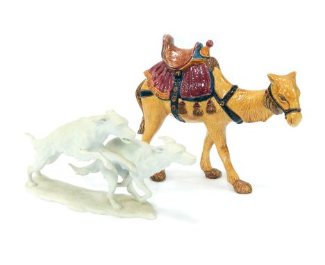 A 20thC Kaiser bisque porcelain figure group, modelled as two running hunting dogs, signed to base C Bachmann, 31cm wide, tog