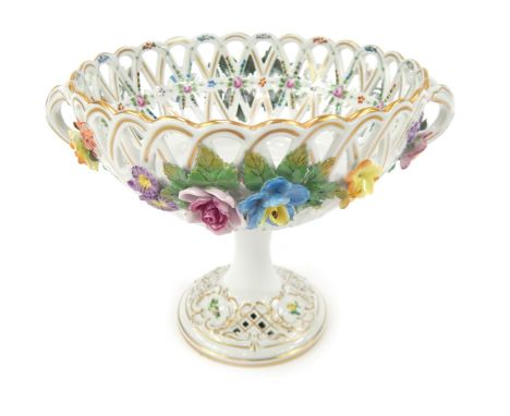 A 20thC Dresden porcelain two handled pedestal dish, the pierced bowl decorated with painted and applied flowers, on a circul