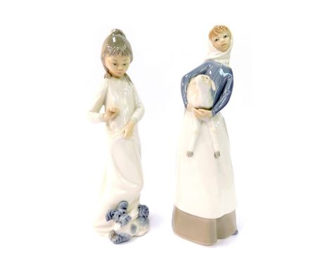 A Lladro figure of a lady carrying lamb, and a Nao figure of a child with puppy. (2)