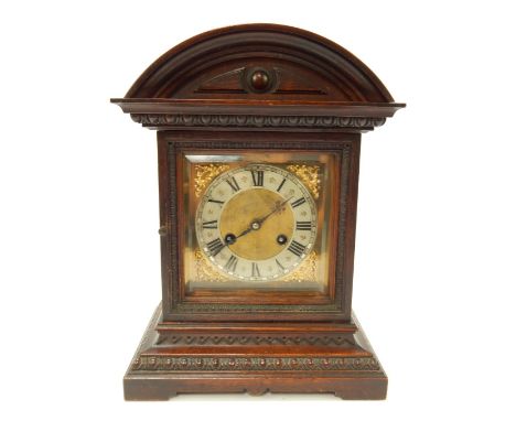 An early 20thC oak cased mantel clock, the square brass dial bearing Roman numerals within a silvered chapter ring, eight day