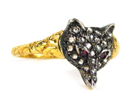 A fox dress ring, the shaped fox's head set with tiny diamonds and two ruby eyes, in white metal on a yellow metal band, unma