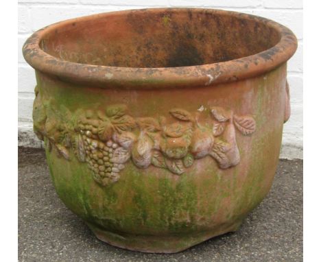 A terracotta planter, with fruits and bloom swags, 41cm high, 60cm diameter.