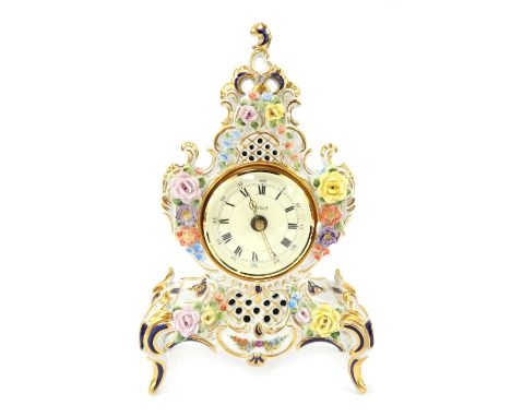 A 20thC Dresden porcelain mantel clock, the circular dial with Roman numerals marked Sandizell, quartz movement, the case wit