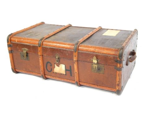 An early 20thC canvas and wooden bound travelling trunk, 97cm wide.