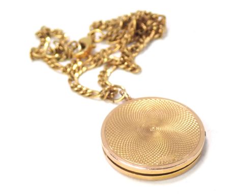 A circular pendant and chain, the 9ct gold circular locket with engine engraved outer case, 3cm wide, on gold plated byzantin
