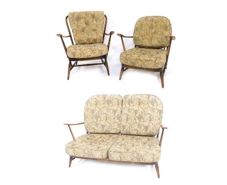 An Ercol dark elm cottage suite, comprising two seater sofa, 122cm wide, and a pair of matching armchairs.