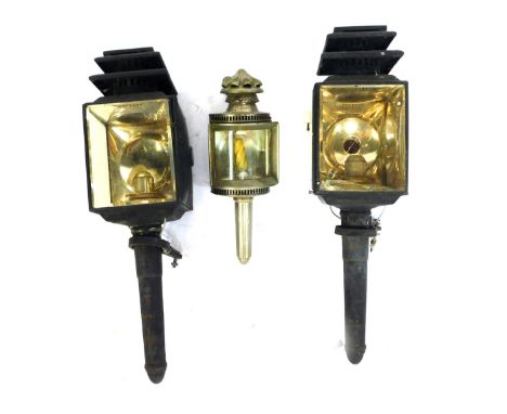 Two 19thC coach lamps, each with a black casing, 53cm high and a later metal cased lamp, 30cm high. (AF) (3)  