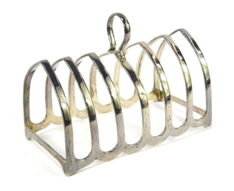 A George V silver six division toast rack, of arched form with ring handle, Birmingham 1931, 12cm wide, 4.40oz.
