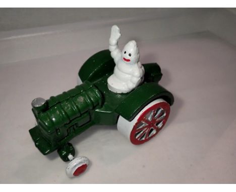 Cast iron Michelin man on tractor, L: 13 cm. P&amp;P Group 1 (£14+VAT for the first lot and £1+VAT for subsequent lots) 